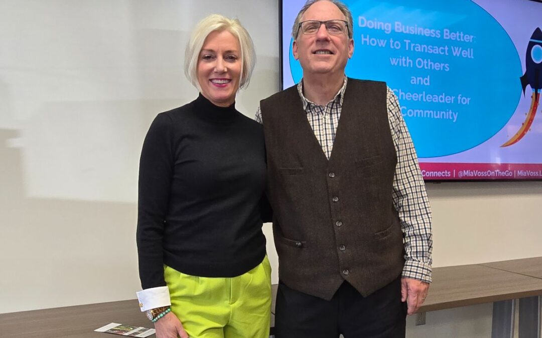 Mia Voss and Tom Quinn standing together